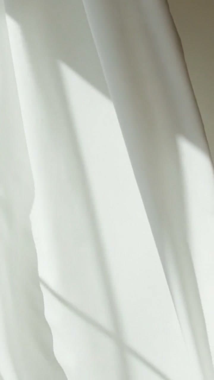 Natural light moving across a soft interior material